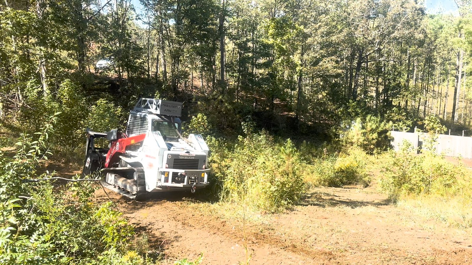 Tracked forestry mulcher clearing vegetation at a Springville, AL campground